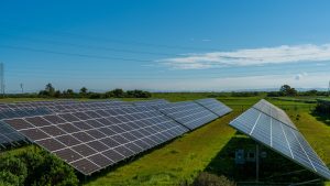 Renewable Energy and Green Technology Solar panels in a lush rural field, generating renewable energy in San Rafael, CA.